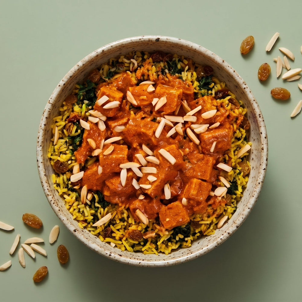 Low Sodium Indian Butter Tofu over spiced yellow rice with slivered almonds and golden raisins.