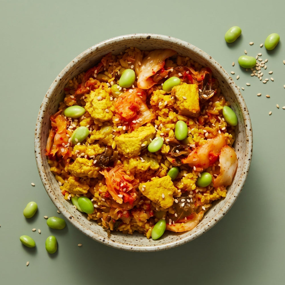 Low Sodium Kimchi Fried Quinoa bowl topped with sautéed vegetables, sesame seeds, and fresh green onions.