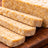 Slices of tempeh on a wooden cutting board