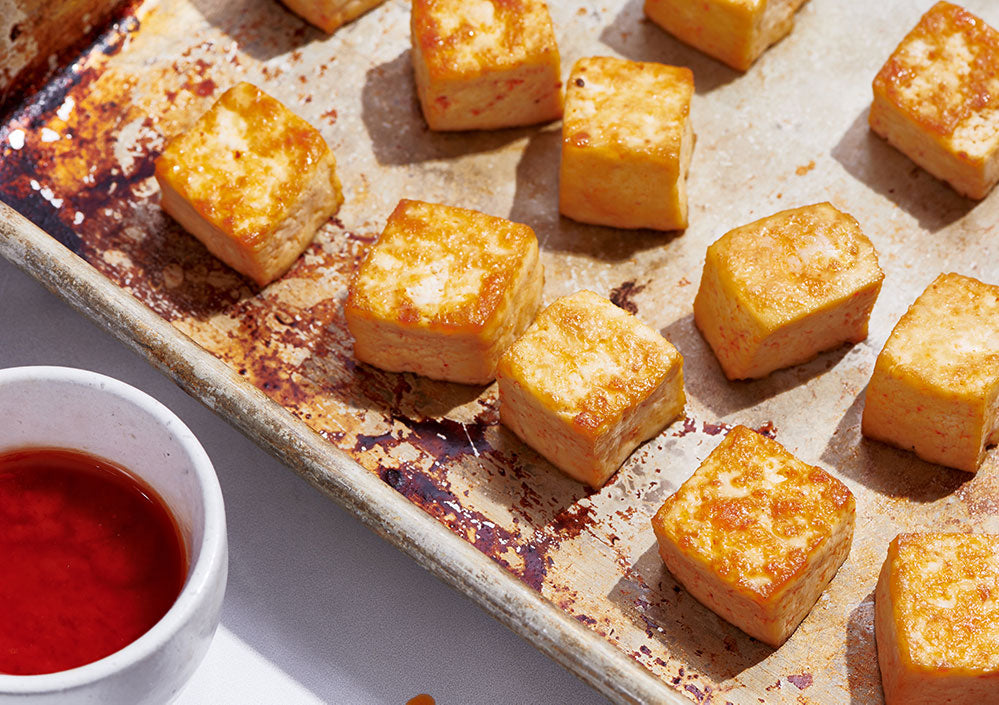 Tofu roasting on a sheet pan